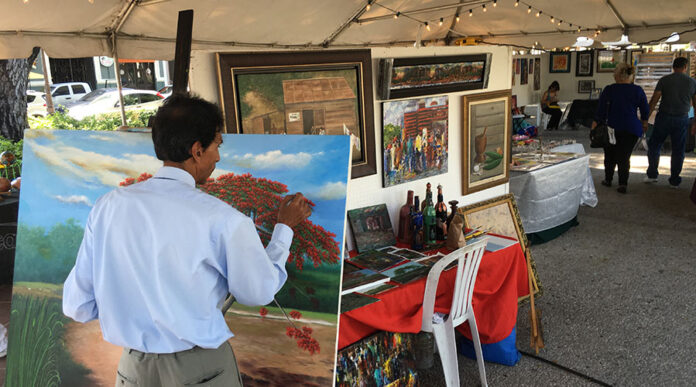 Un artista pinta en vivo durante la Feria de Artesanías y Muestra de Arte. (Voces del Sur)
